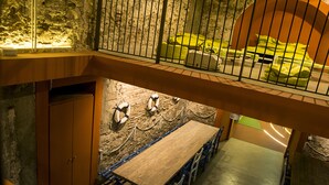 Un hôtel à plusieurs étages comprenant un espace repas, une cuisine située au niveau inférieur et un balcon avec un lit.
