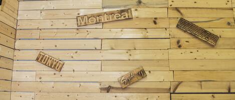 A wooden wall with city names like Berlin, Moscow, and Sydney.