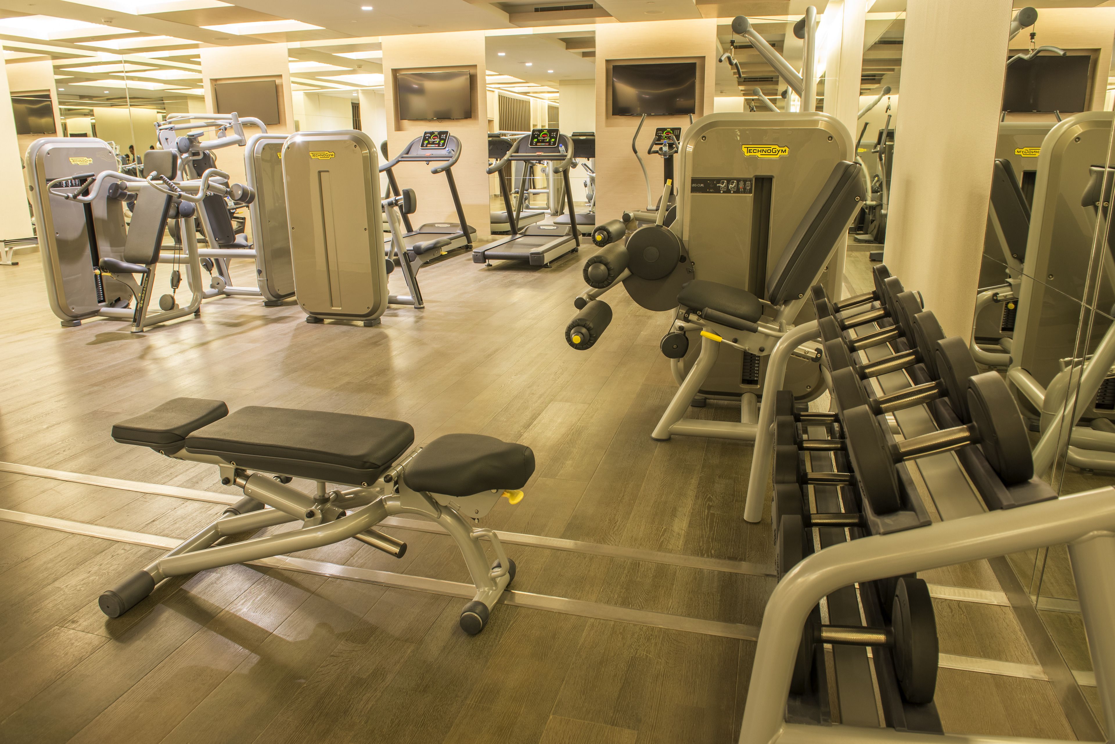 A gym with various exercise machines, including treadmills and weight benches.