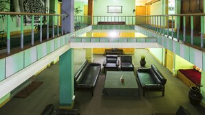 A multi-level interior with a central seating area, a staircase, and a tapestry on the wall. - The Nana Hotels (Kathmandu)