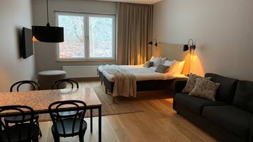 Family Quadruple Room, Kitchenette | Living area | Flat-screen TV