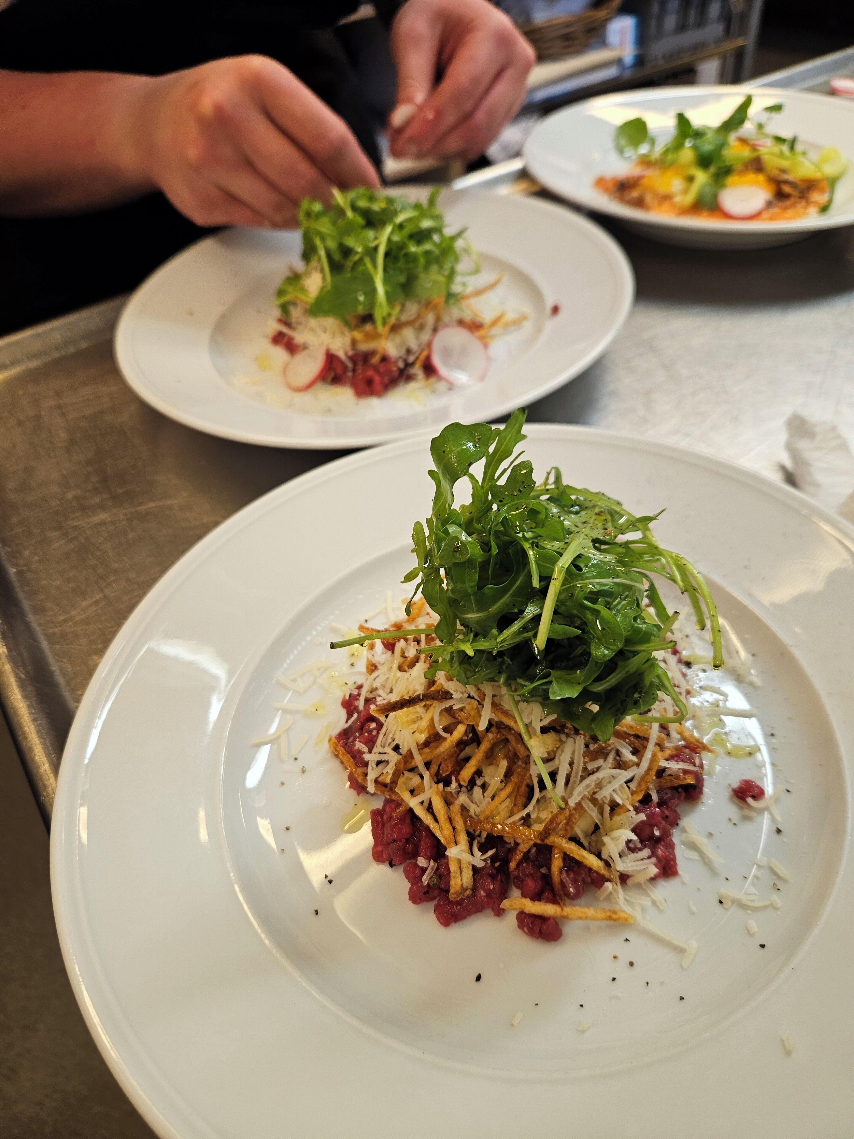 A restaurant setting with a focus on a plated dish.