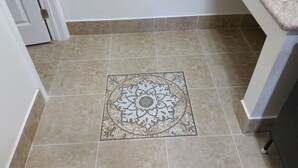 Un sol carrelé orné d’un motif décoratif central.