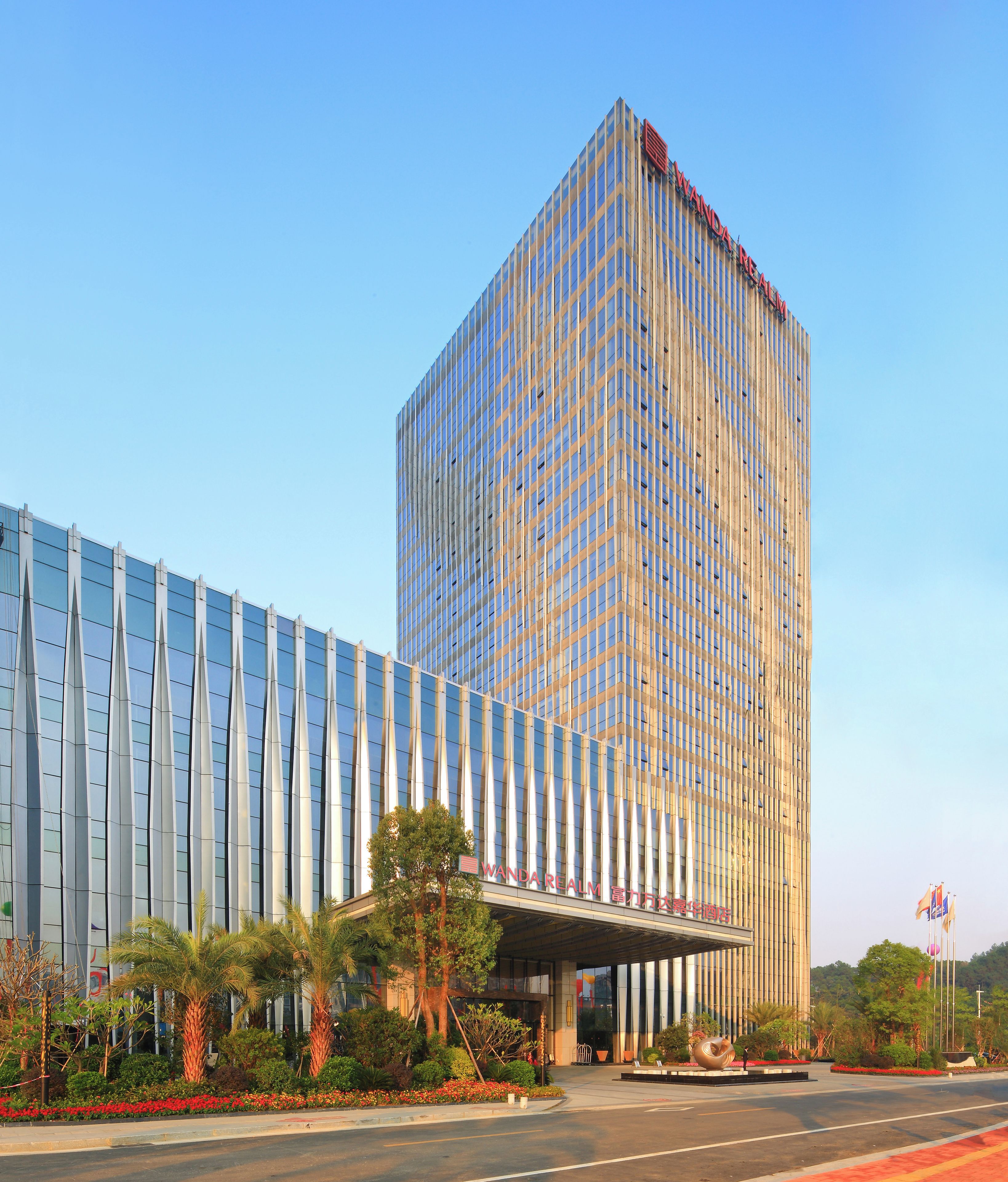 A modern building with a prominent vertical facade and a large entrance.