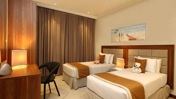 A hotel room with two beds, a desk, a chair, and a painting on the wall.