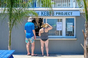 A building with a sign reading "The KEBE PROJECT". - Commander Hotel & Suites (Ocean City)