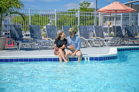 Indoor pool, outdoor pool, sun loungers. Commander Hotel & Suites