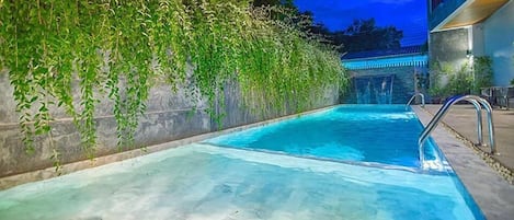 Outdoor pool, a waterfall pool, pool loungers