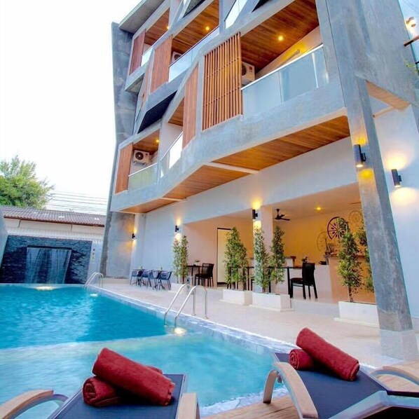 Outdoor pool, a waterfall pool, sun loungers