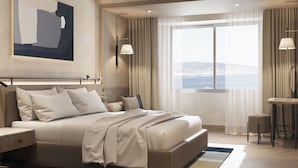 A modern hotel room with a large bed, a desk, and a view of the sea. - Kolin Hotel Spa & Convention Center (Çanakkale)