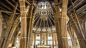 A bamboo interior with a central seating area, large windows, and a high ceiling. - Naman Retreat (Da Nang)