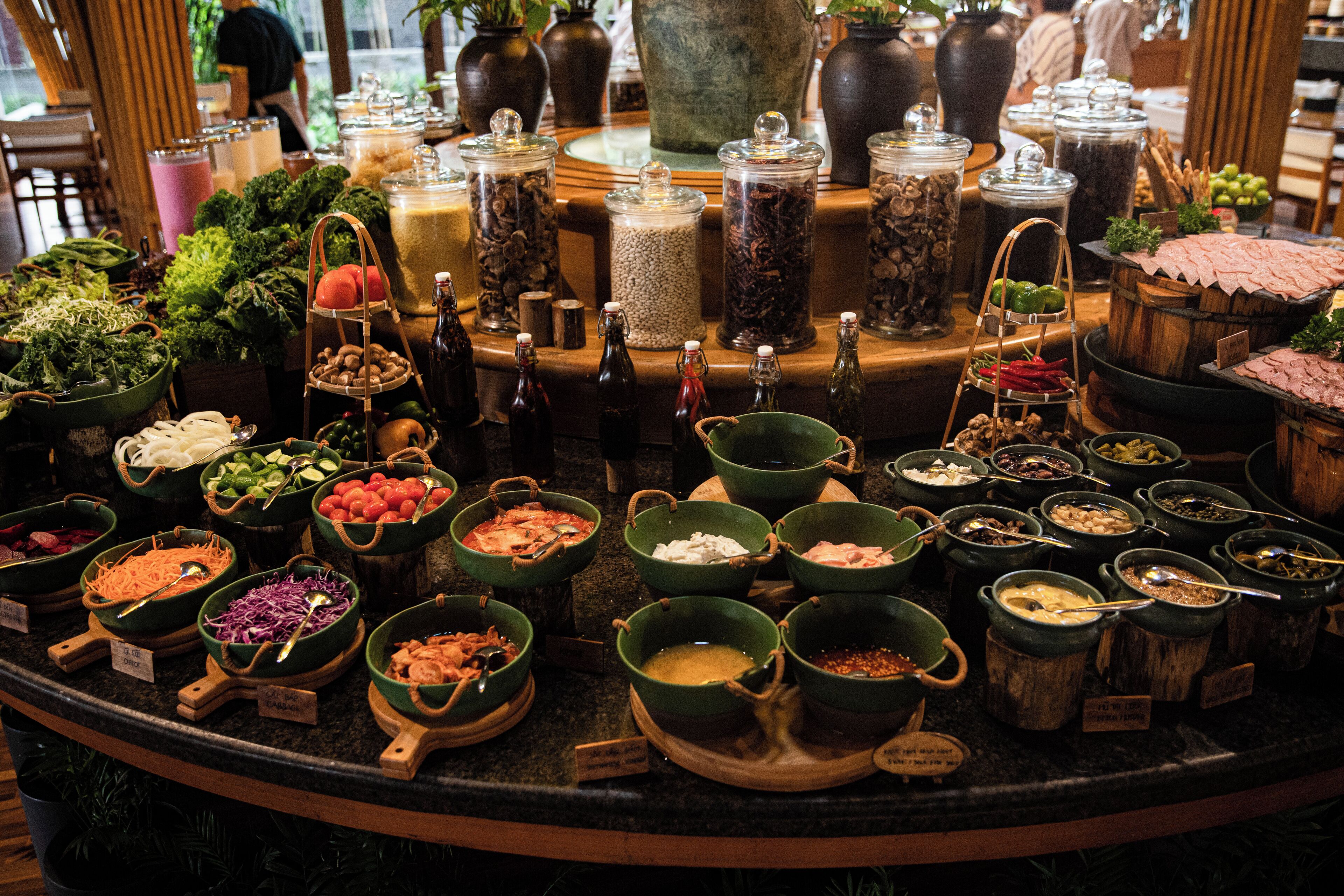 A buffet with various food items and condiments.