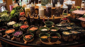 A buffet with various food items and condiments.