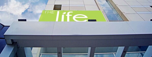 A building with a sign reading "THE life". - The Life Hotels (Surabaya)