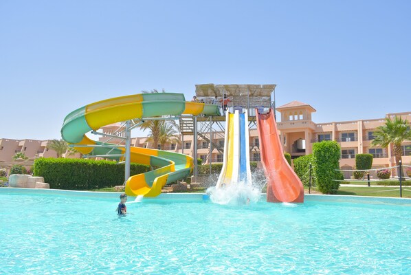 A water park with multiple water slides and a pool.