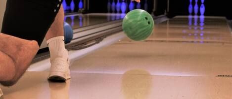 A person bowling in a bowling alley.