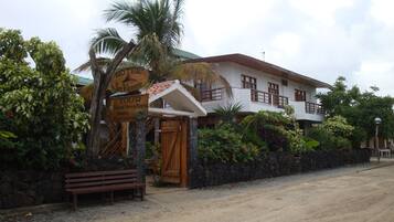 A two-story building with a sign for Hotel San Vicente.