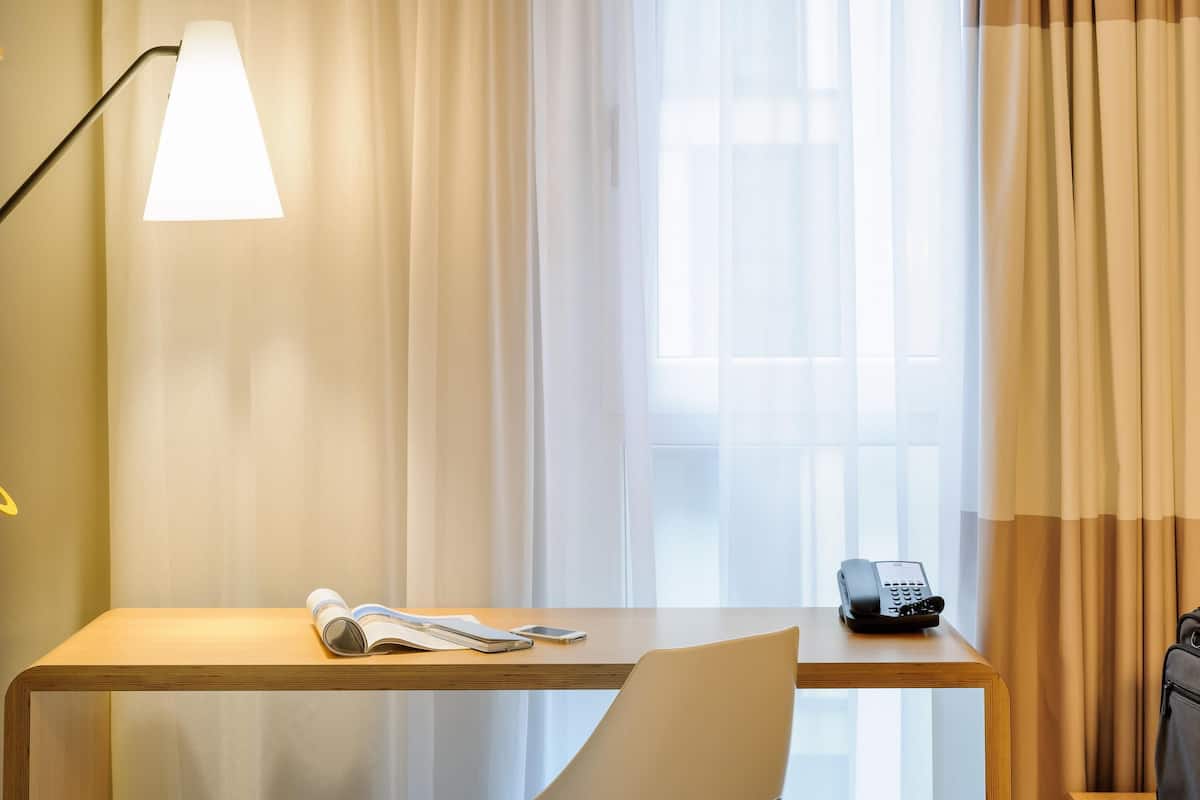 Hypo-allergenic bedding, desk, laptop workspace, blackout curtains