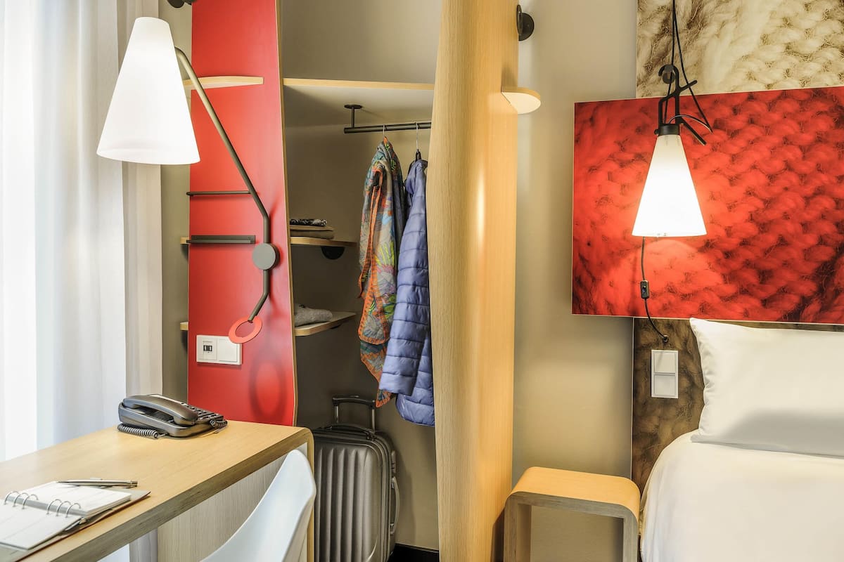 Hypo-allergenic bedding, desk, laptop workspace, blackout drapes