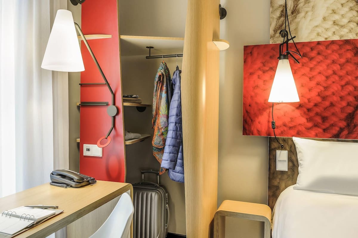 Hypo-allergenic bedding, desk, laptop workspace, blackout drapes