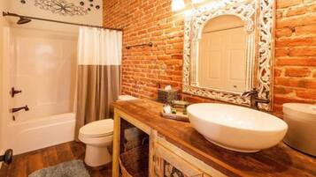 Room, 1 King Bed (New Orleans) | Bathroom | Combined shower/bathtub, designer toiletries, hair dryer, bathrobes