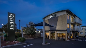 A modern building with a sign reading "QUEST" and a storefront with the number "377". - Quest Frankston (Frankston)