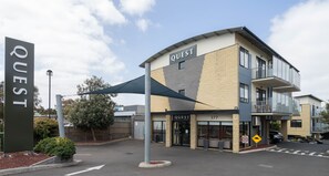 A modern building with a sign reading "QUEST" and the number "377" on the facade. - Quest Frankston (Frankston)