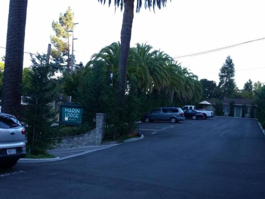 A parking lot with a sign for 'Marin Lodge.'