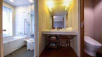 A bathroom with a bathtub, toilet, and sink.