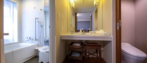 A bathroom with a bathtub, toilet, and sink.