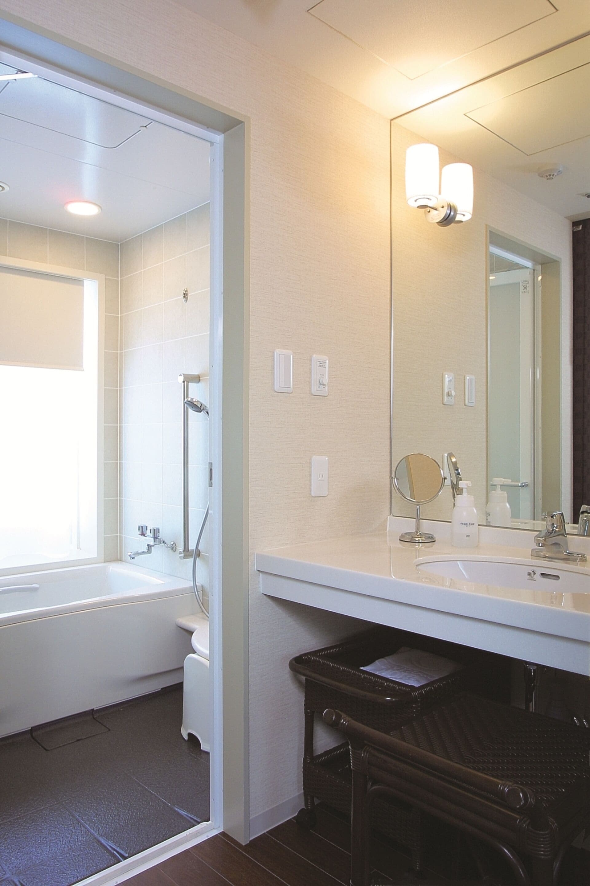 A bathroom with a bathtub, a sink, a mirror, and a shower.