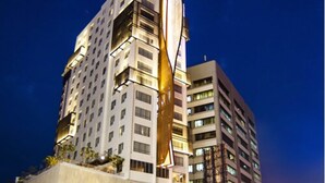 Un hotel moderno de gran altura, con múltiples pisos y balcones.