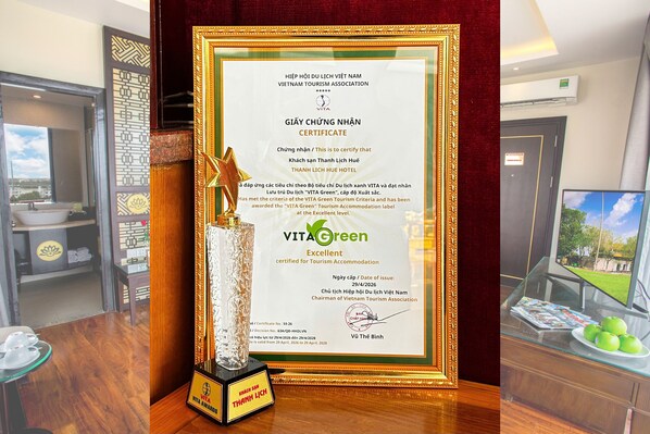 A framed certificate for Thanh Lich Hue Hotel, indicating it is a VITA Green Tourism Accommodation.