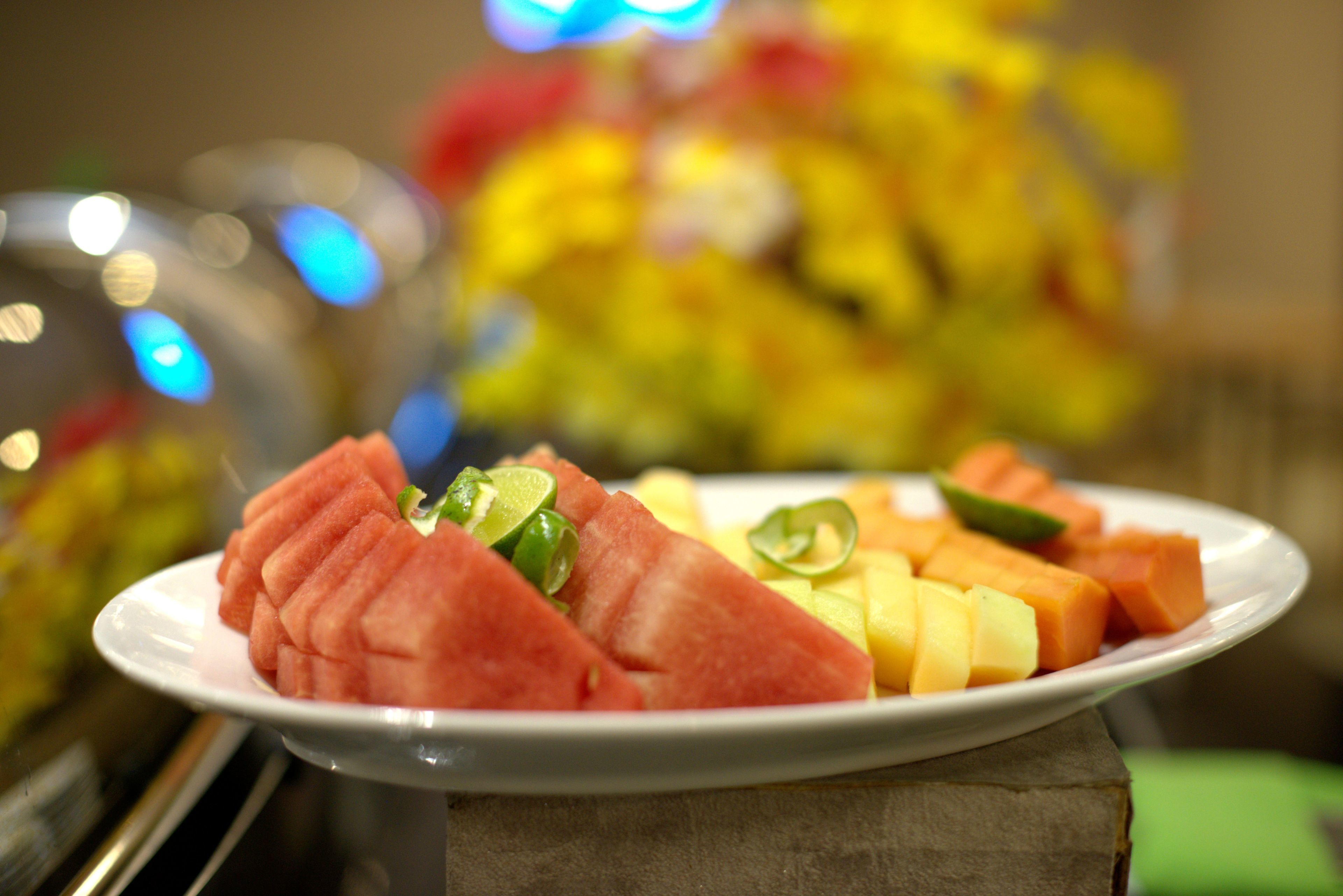 A plate of watermelon and cantaloupe on a table.