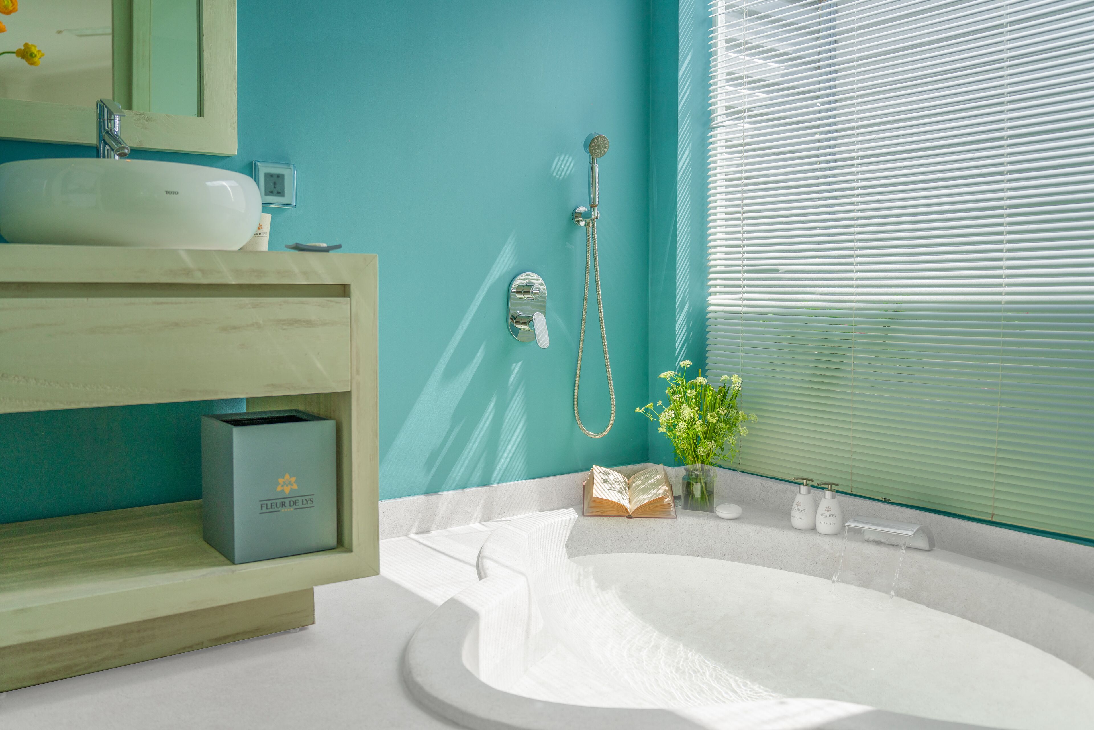 A modern bathroom with a white bathtub, a sink, and a shower.