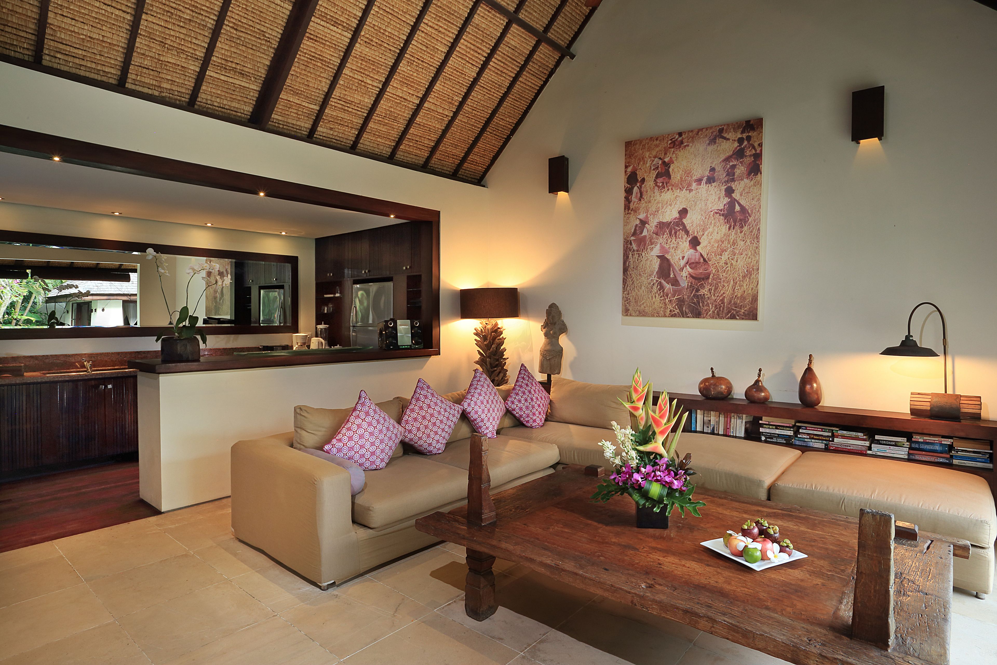 A modern living room with a sofa, coffee table, and a bookshelf.
