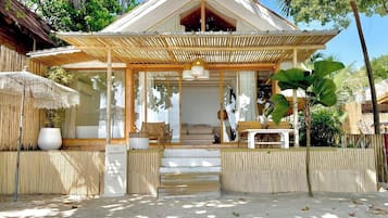 A resort with a covered entrance, outdoor seating, and a sign indicating guest-only areas.