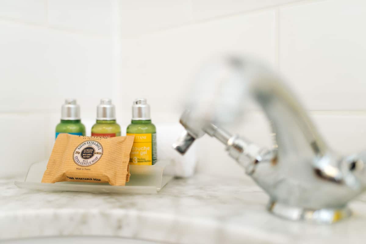 designer toiletries, hair dryer, towels, soap