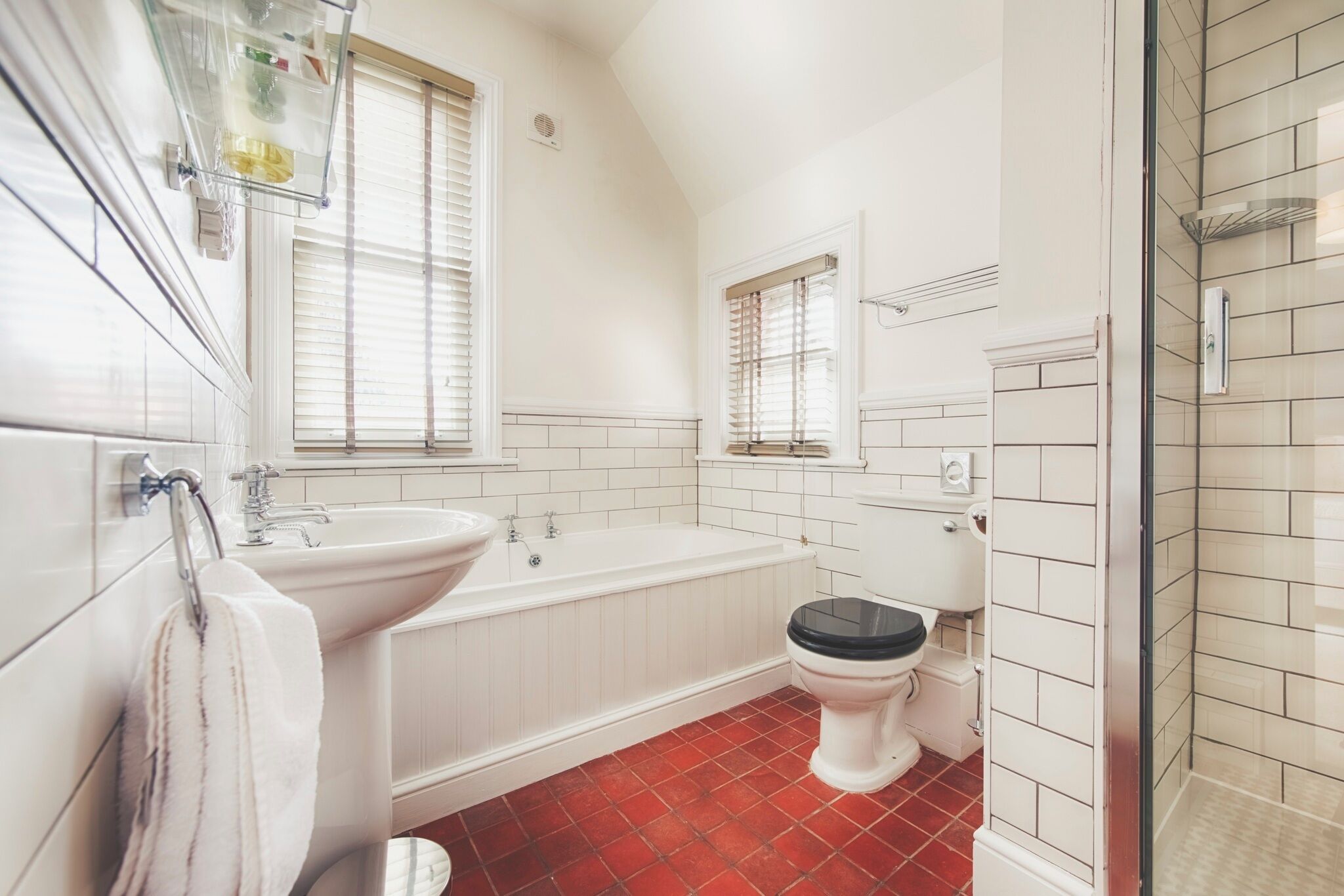 A bathroom with a bathtub, toilet, and shower.