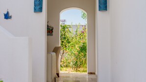A reception area with a sign, a star decoration, and a view of greenery outside. - Via Farilya Hotel (Bodrum)