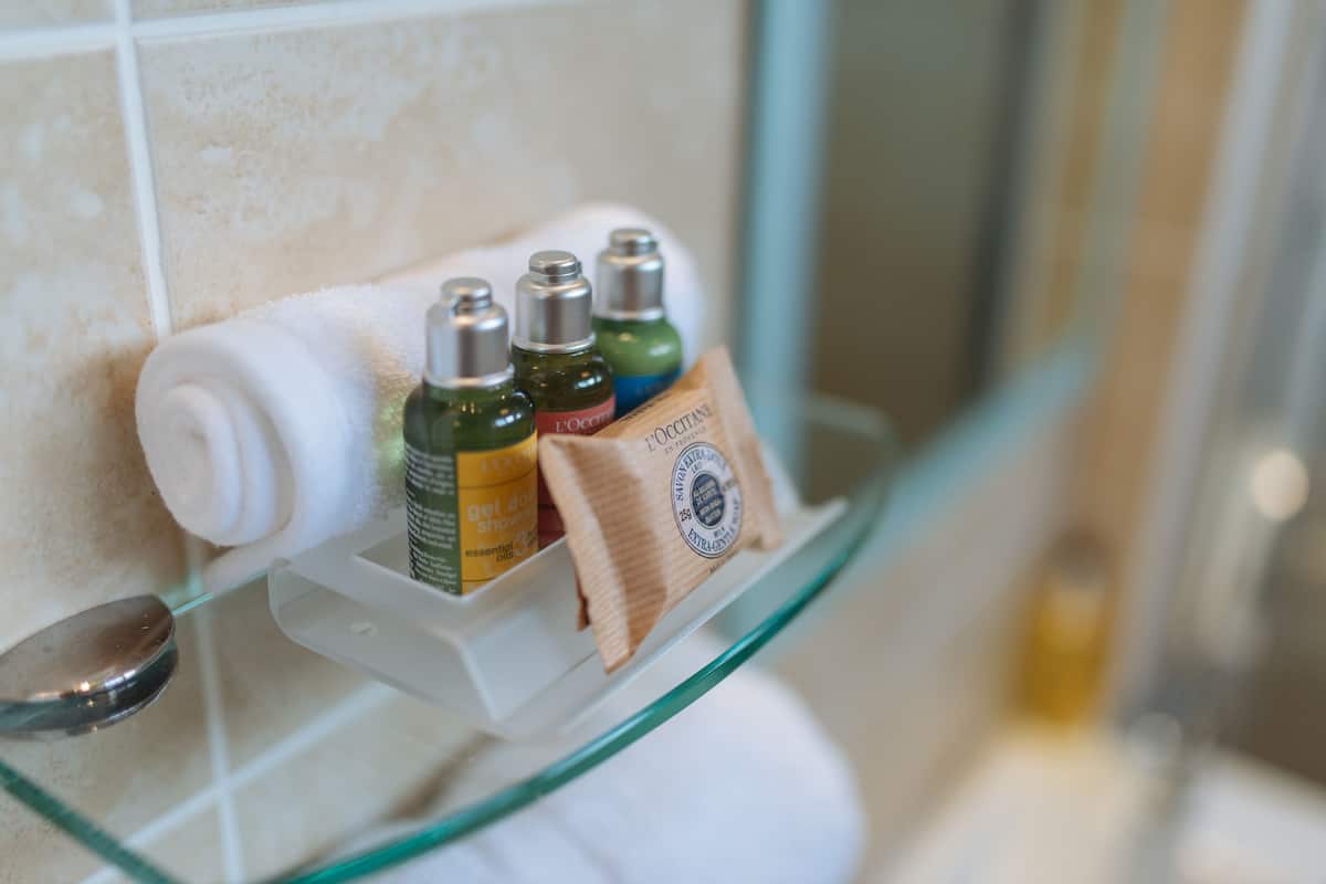 designer toiletries, hair dryer, towels, soap