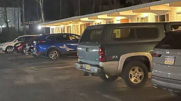 A parking lot with several SUVs parked.