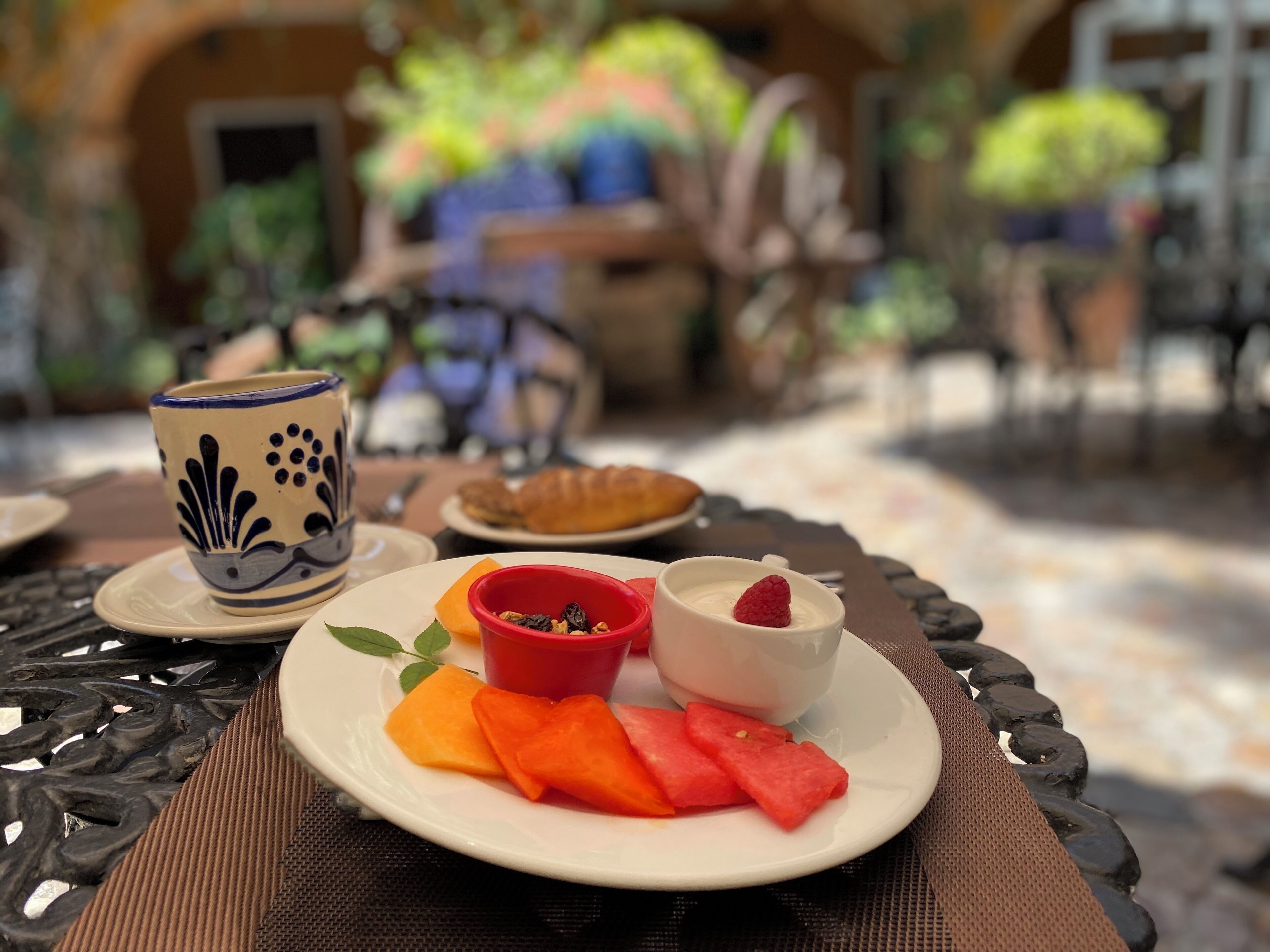 Una mesa con una porción de sandía y una taza de café.