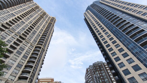 Two high-rise buildings with a clear sky. - Maplewood Suites - Square One (Mississauga)