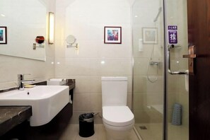 A modern bathroom with a large sink, toilet, and glass shower enclosure. - Tangyue Hotel (Yan'an)