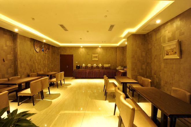 A conference room with a long table, chairs, and a podium.