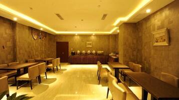 A conference room with a long table, chairs, and a podium.