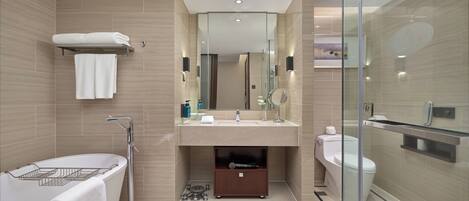 A modern bathroom with a bathtub, a toilet, and a glass-enclosed shower area.