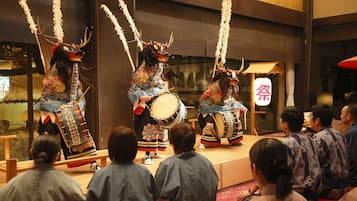 A traditional performance with performers in elaborate costumes and masks.