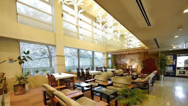 A spacious lobby with a high ceiling, large windows, and a variety of seating arrangements including sofas and chairs. - Hotel Fukui Castle (Fukui)